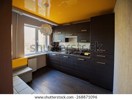 Beautiful designer kitchen in brown and yellow colors.