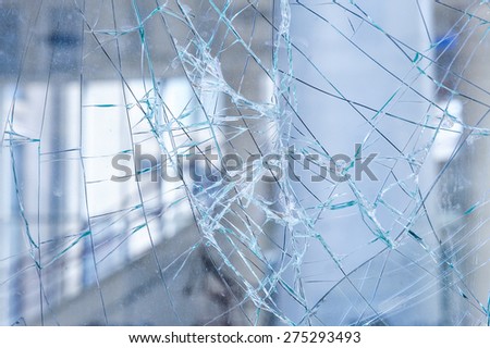 Cracked glass in a shop window closeup.