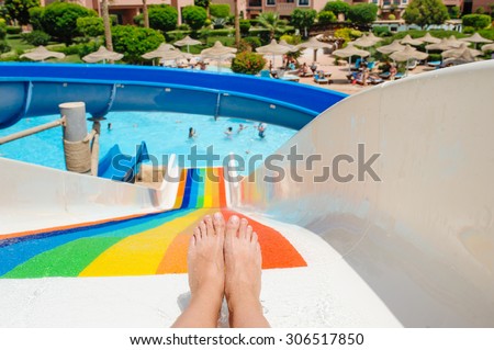 beautiful young woman pulls off the slides in the water park