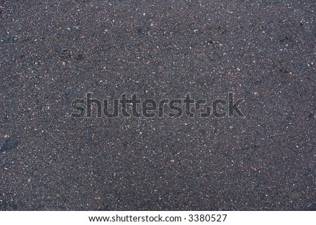 a texture or background image of a black tar asphalt road surface made of bitumen.