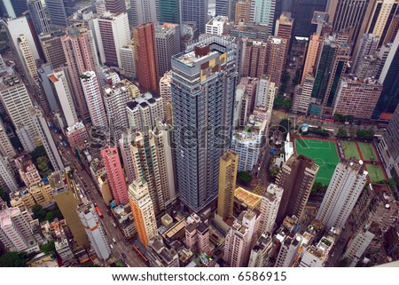 Looking down on Wan Chai Hong Kong as seen from the top of a tall building. a built out tightly congested futuristic cityscape if ever there was.
