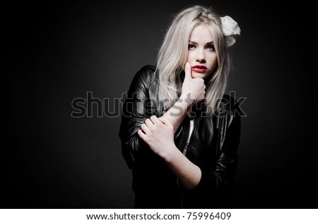 Beautiful sexy blond girl in leather jacket with red lipstick