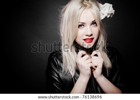 Closeup portrait of a beautiful sexy blond girl in leather jacket and red lipstick