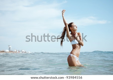Fashion shot of a beautiful girl in a white bikini sunbathing on the sea. Kazantip, Crimea