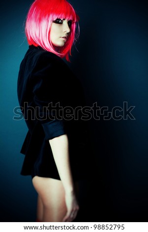 professional model, posing in a studio in a pink wig and bright make-up