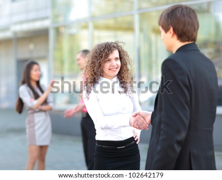 Business partners handshaking after negotiating and signing contract