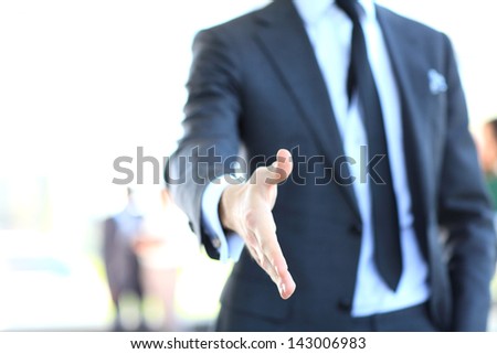 A business man with an open hand ready to seal a deal