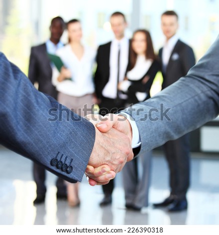 Closeup of a business handshake. Business people shaking hands, finishing up a meeting