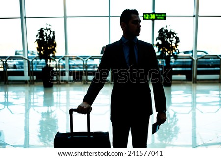 businessman with luggage in airport
