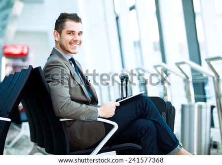 modern businessman using tablet computer at airport modern businessman using tablet computer at airport