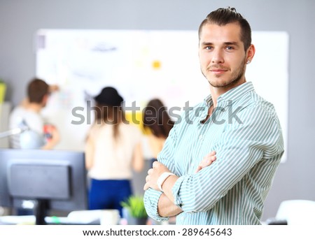 Image of smart young businessmen looking at camera at meeting