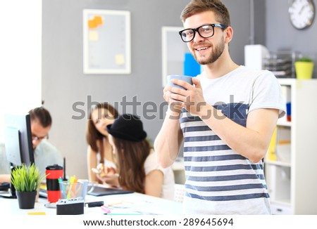 Image of smart young businessmen looking at camera at meeting