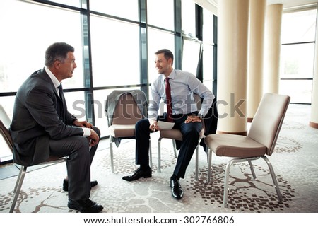 Coworkers discussing project in conference room