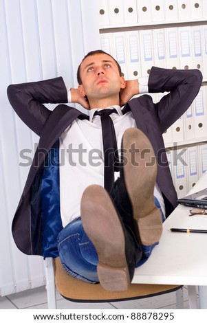 relaxed and dreaming business man sits on office chair