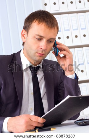 Business man working at office and calling on phone