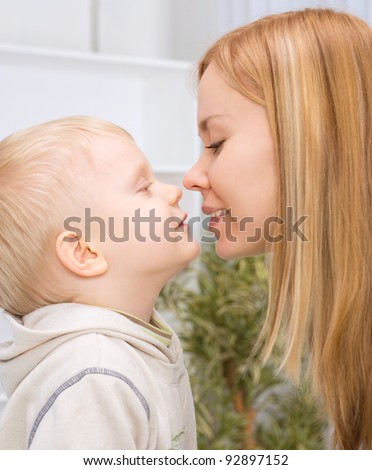 mother and son about to kiss
