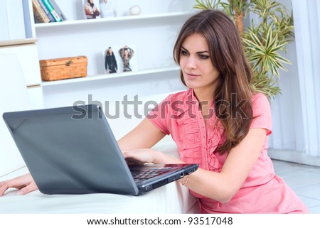 happy young beautiful woman with laptop - indoors