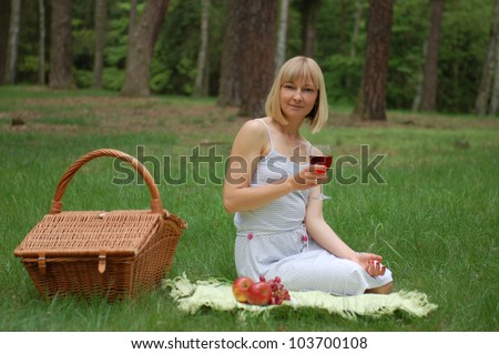Young woman having a picnic in the wood
