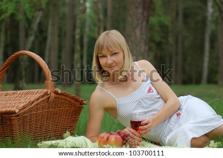 Young woman having a picnic in the wood