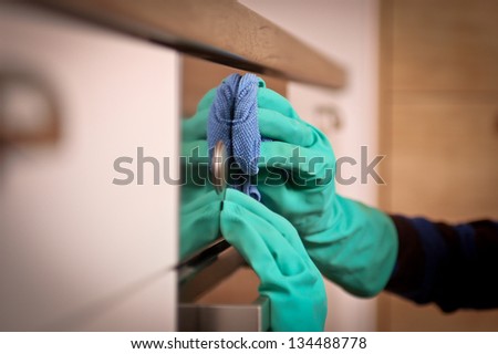 Close-up of human hands polishing the oven