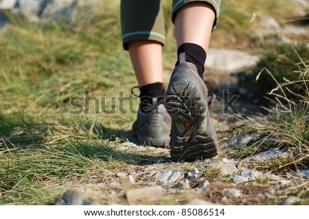 Hiking Boots/Hiking Boots and Legs of a Woman on the Mountain Path