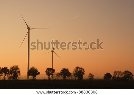 sunset windmill/wind turbines in the country side over sunset