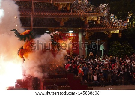 TAIPEI, TAIWAN-APRIL 23: Baosheng cultural festival is hosted for the birthday of the Baosheng Emperor on April 23, 2013 in Taipei, Taiwan. A paper-made lion is fired during the ceremony.