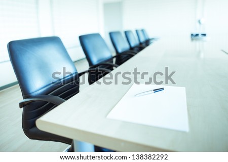 Corporate Office Chairs In A Boardroom With Pen And Paper