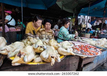 BATTAMBANG, CAMBODIA - MAY 18: A woman sells food at her stall in a busy market, in Battambang, Cambodia on May 18 2012