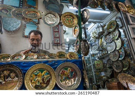 TUNIS, TUNISIA - MAY 12: A metal smith sits creating new items for sale in a souk in the capital, in Tunis, Tunisia on May 12, 2012.