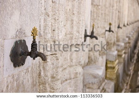 A row of faucets for ablution in Suleiman\'s mosque, Istanbul, Turkey