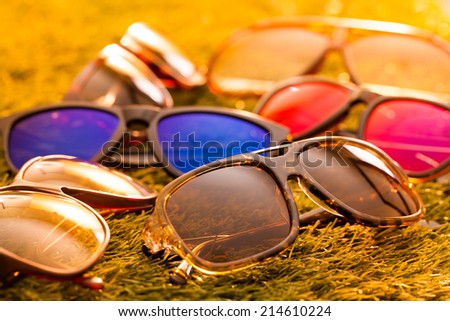 Collection of sunglasses on grass background