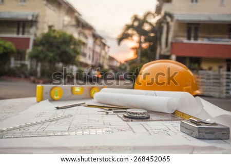 Tools on architect blueprints with house Tools on architect blueprints with house
