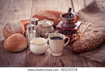 Coffee antique grinder, coffee beans and bread.