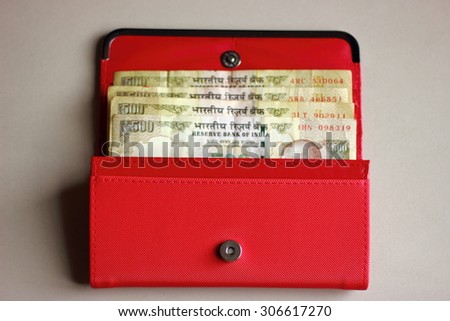 Indian currency notes in a ladies purse