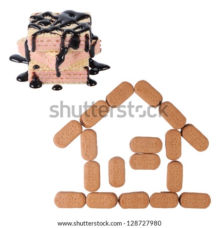 Wafer with melted chocolate and biscuits form the house structure, isolated on white background