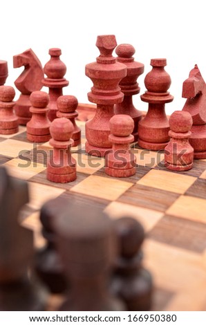 Wooden chess pieces on a chess board is unique, isolated on white background