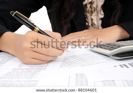 businesswoman\'s hand writing with pen and calculator, isolated on white background