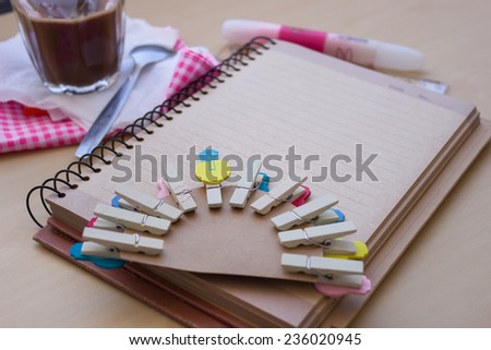 wooden clip set for paper clip, morning coffee and set of working out put on the wooden table. concept of start your life, new idea and focus to the yellow wooden clip