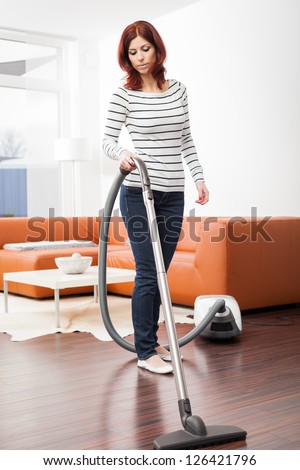 Attractive Female With Vacuum Cleaner