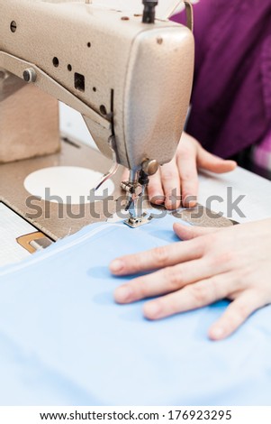 Sewing machine stitching blue tissue