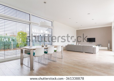 Interior of a modern bright dining-room with large windows