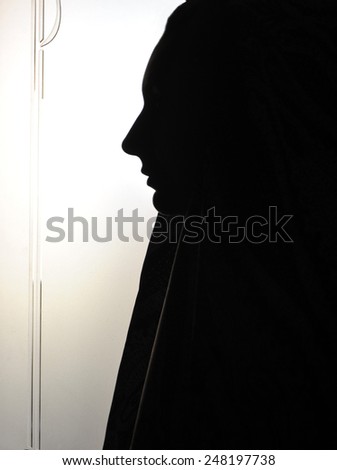 woman's face profile wearing yashmak in black and white