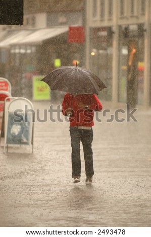 Man is running in the rain. Motion blur.