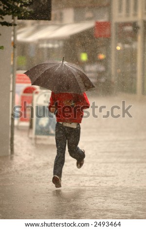 Man running in the rain. Motion blur.