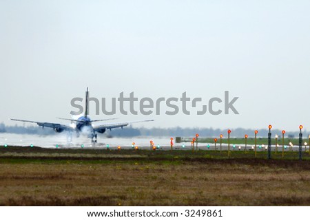 Plane has just landet in an airport. Note the picture is in blur because of the heat from the engine and the smoke from the wheels.