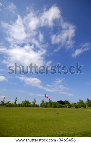 Golf cours with blue and cloudy sky