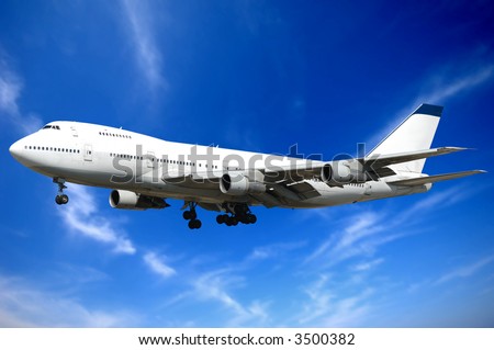 Jumbo jet and blue and cloudy sky.