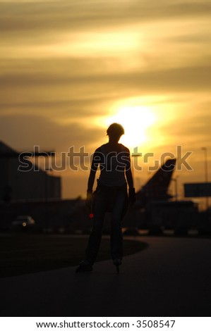 Silhouette of a active woman is running on roller blades