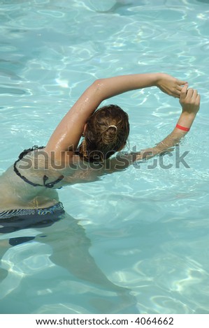 Girl in pool doing aerobic